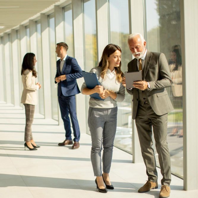 modern-business-people-using-digital-tablet-office-corridor